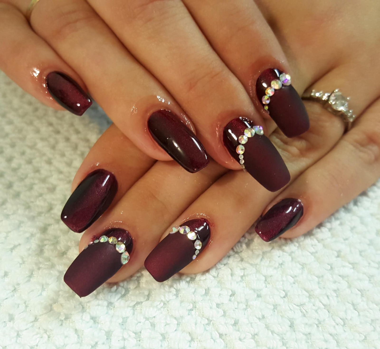 Dark red gel nails with crystal detail